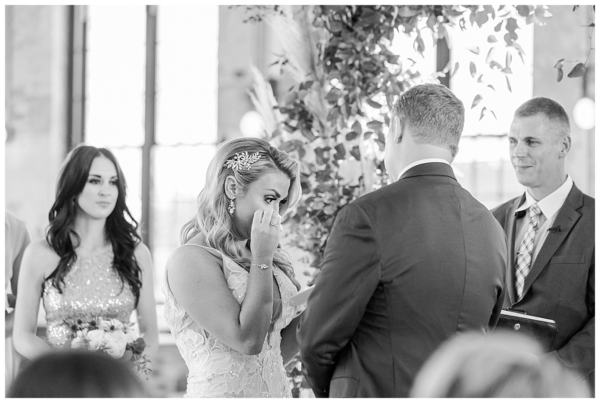 bride crying during ceremony black and white photo