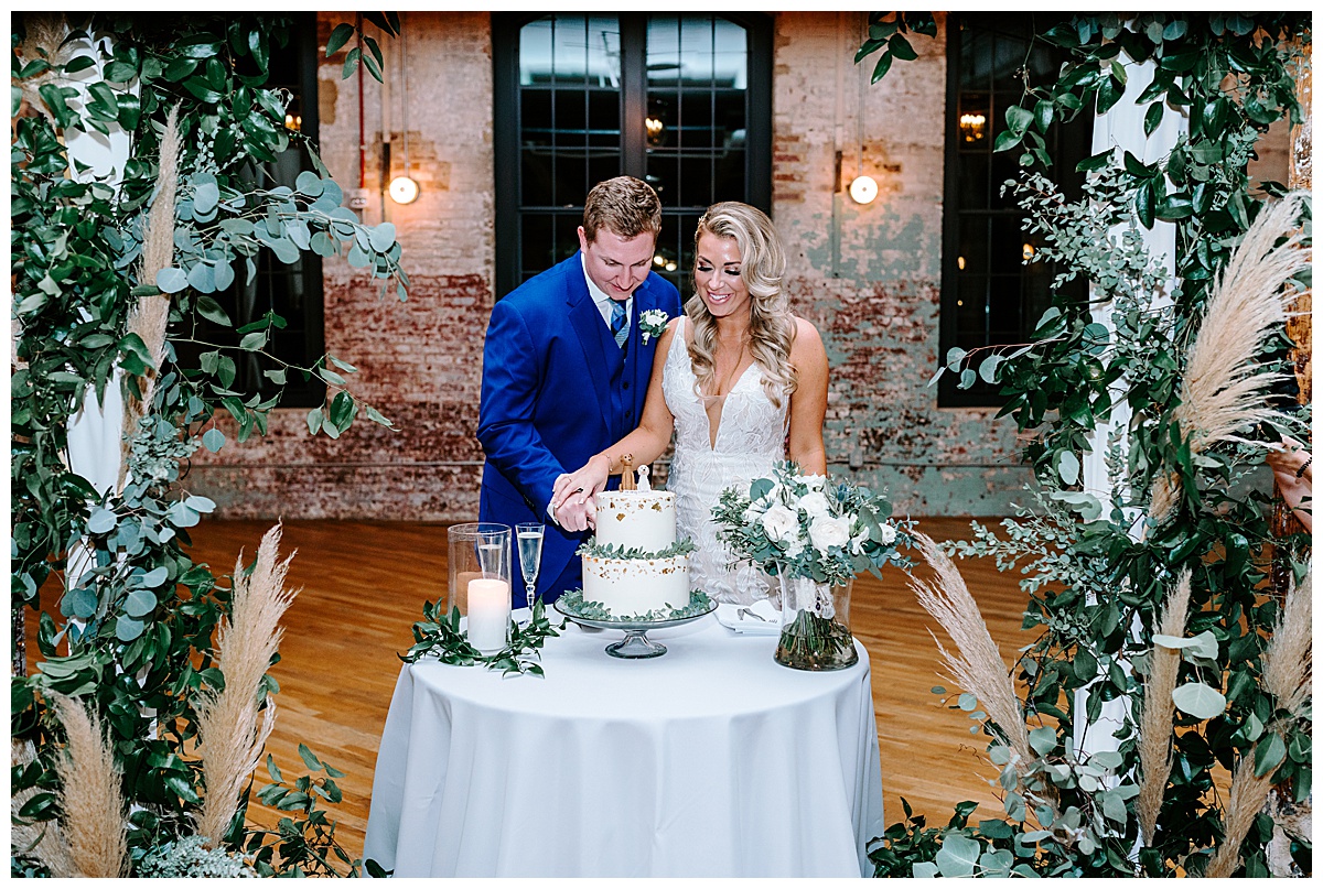 bride and groom cutting their wedding cake at the ceremony