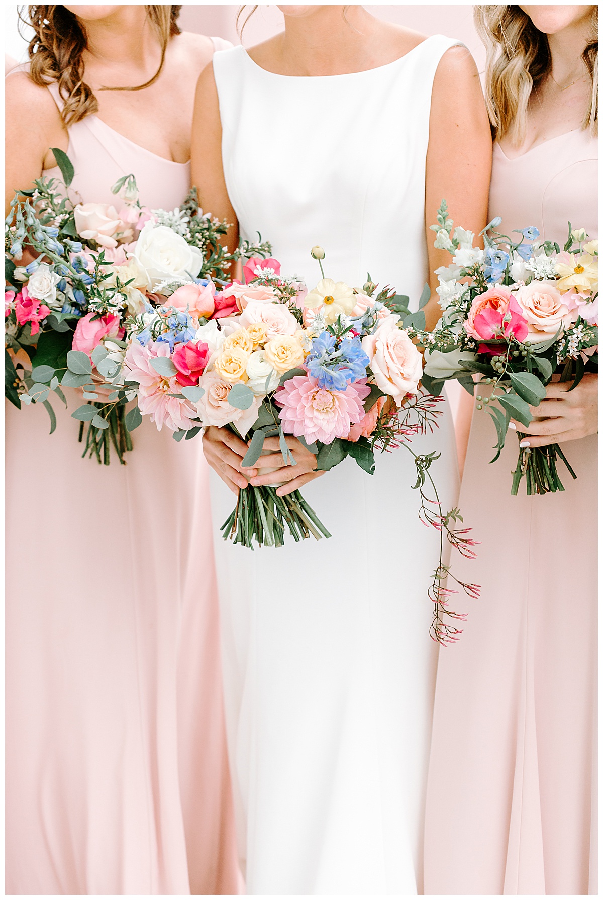 bride and bridesmaids holding flowers